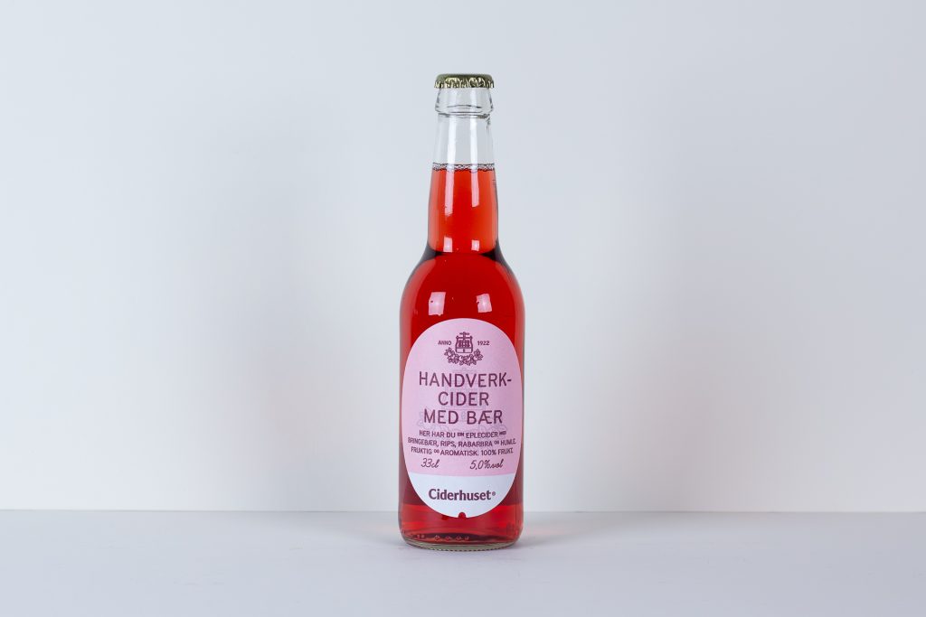Bottle of pink cider with a pink label centered on a white background