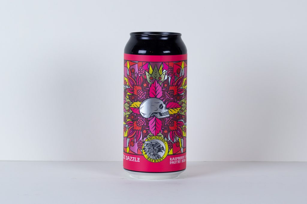 Tall beer can with a psychedelic pink label featuring a skull and vibrant leaves against a plain background