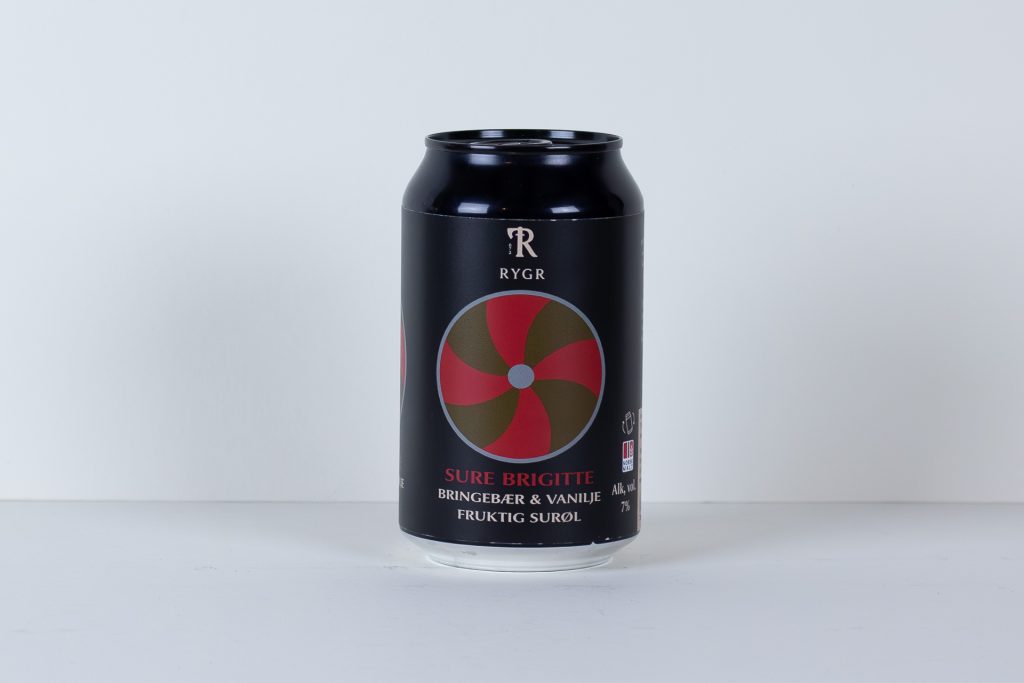 Black aluminum can with a red circular swirl logo and white lettering on a dark background placed on a white surface